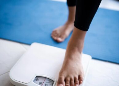 "Person stepping on weighing scale as part of weight loss journey at Dr. Pankti's REVIVE Clinic Borivali - safe inch loss with Ulipolysis, Mesolipolysis and Slim@home."