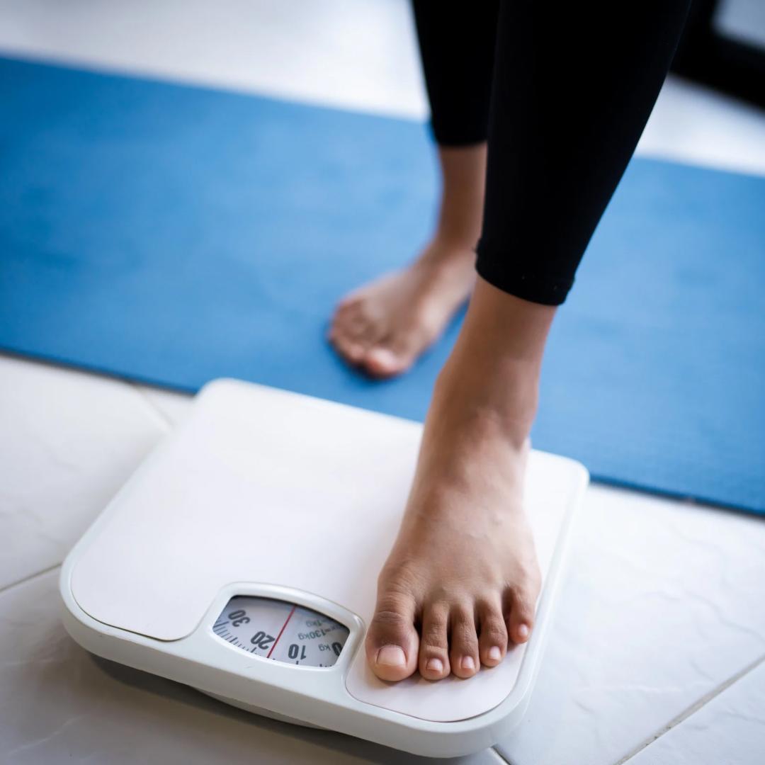 "Person stepping on weighing scale as part of weight loss journey at Dr. Pankti's REVIVE Clinic Borivali - safe inch loss with Ulipolysis, Mesolipolysis and Slim@home."